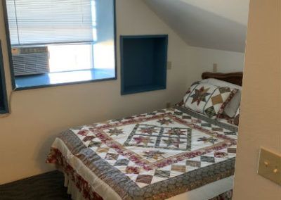 Queen bed in the Junior Suite at the Sugarloaf Mountain Motel in Virginia City, Nevada