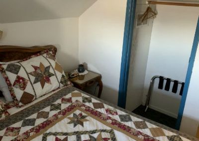 Bed and closet in the Junior Suite at the Sugarloaf Mountain Motel in Virginia City, Nevada